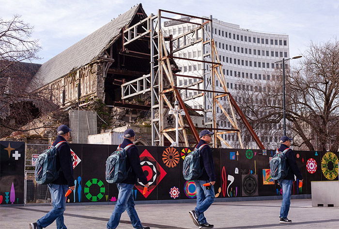 A fun multiplicity photography example of four of the same man walking down a street 