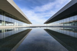 A symmetrical, outdoor, architecture photo of a modern building