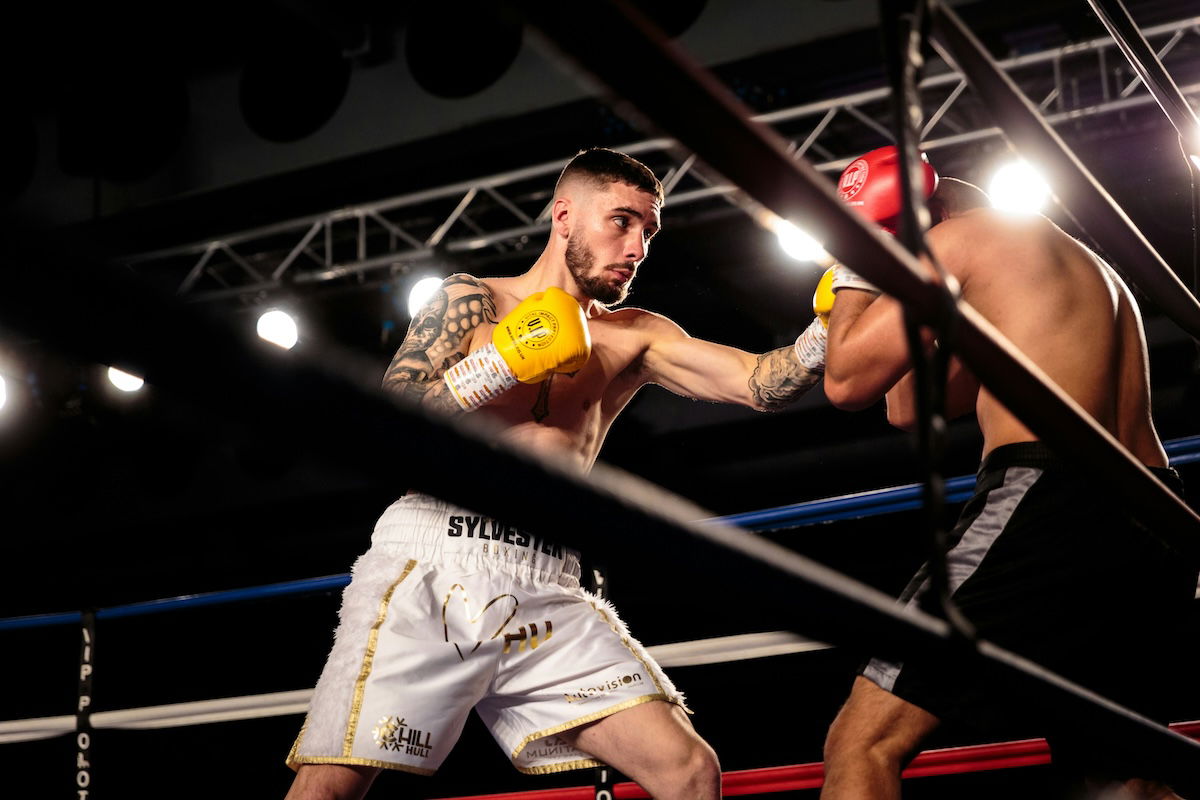 Two boxers sparring in a ring as an example of sports photography