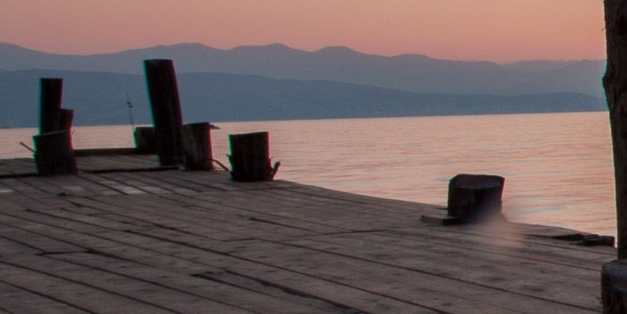 A crop of a seascape image showing quite strong chromatic illustration along the poles of the dock.