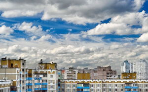 Dramatic cumulonimbus clouds on blue sky over cityscape