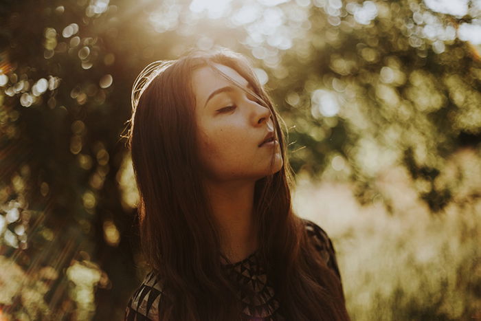 Atmospheric outdoor portrait of a female model using ambient light from the golden hour