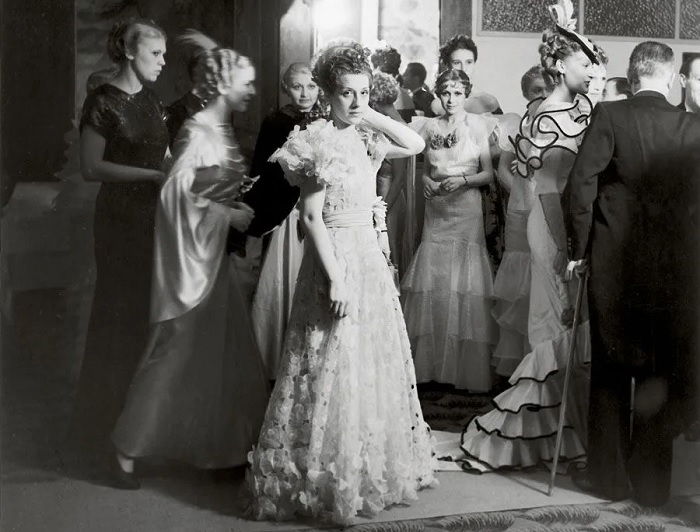 Woman in dress surround by others