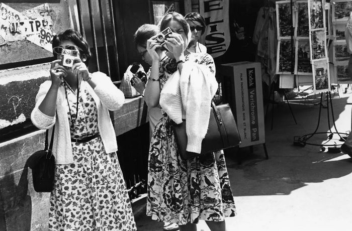 Two ladies in the street taking pictures