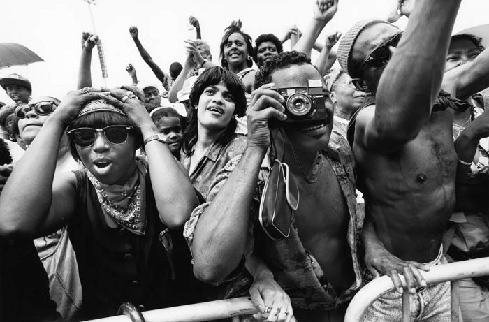 Crowd of people with one man using a camera