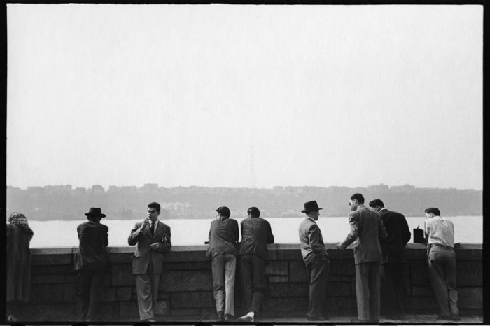 Men leaning against the wall