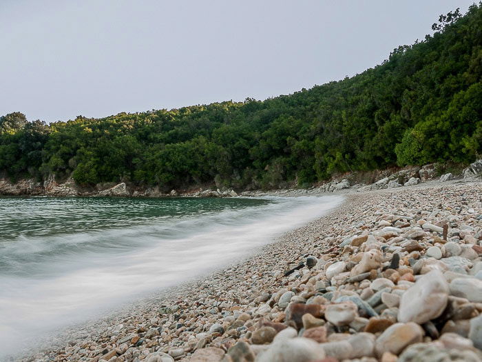 Waves breaking on the shore of Avlaki beach in Kerkyra Greece with motion blur in the waves