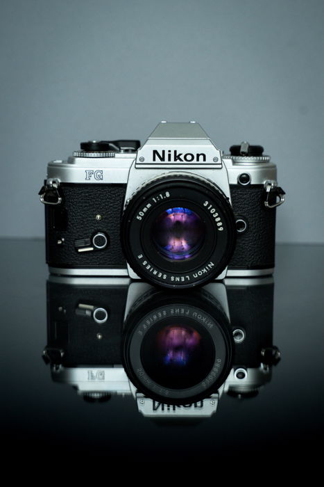 Nikon SLR camera on a reflective surface