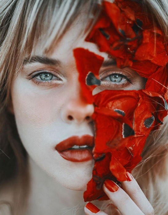 Close portrait of woman with half flower mask