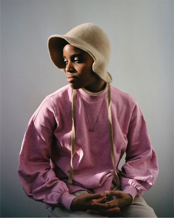 portrait of a girl in a pink jumper and hat