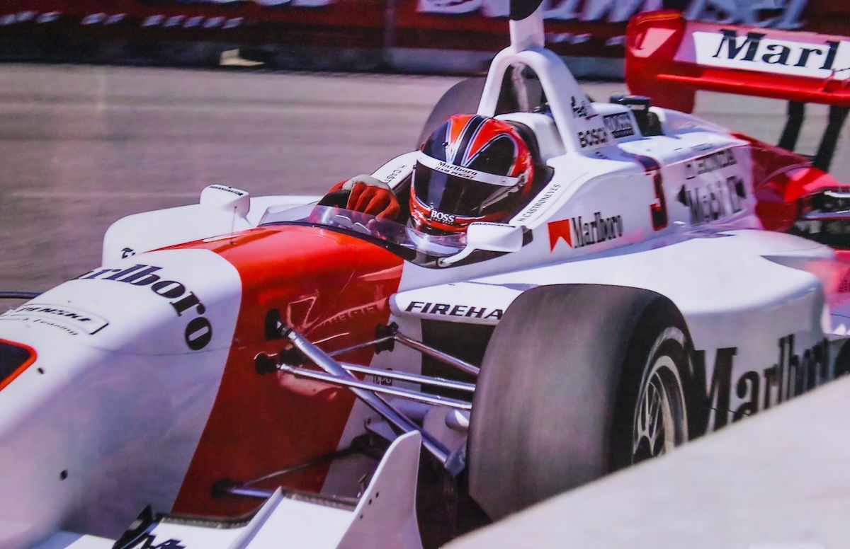 Close-up of race car driver driving a race car taken with a fast shutter speed