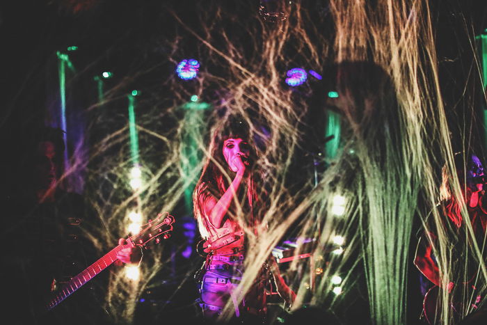 A low light concert photography shot of a musician onstage, shot with a Sony a7R III mirrorless camera