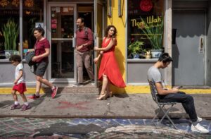 Busy street scene outside a shop front