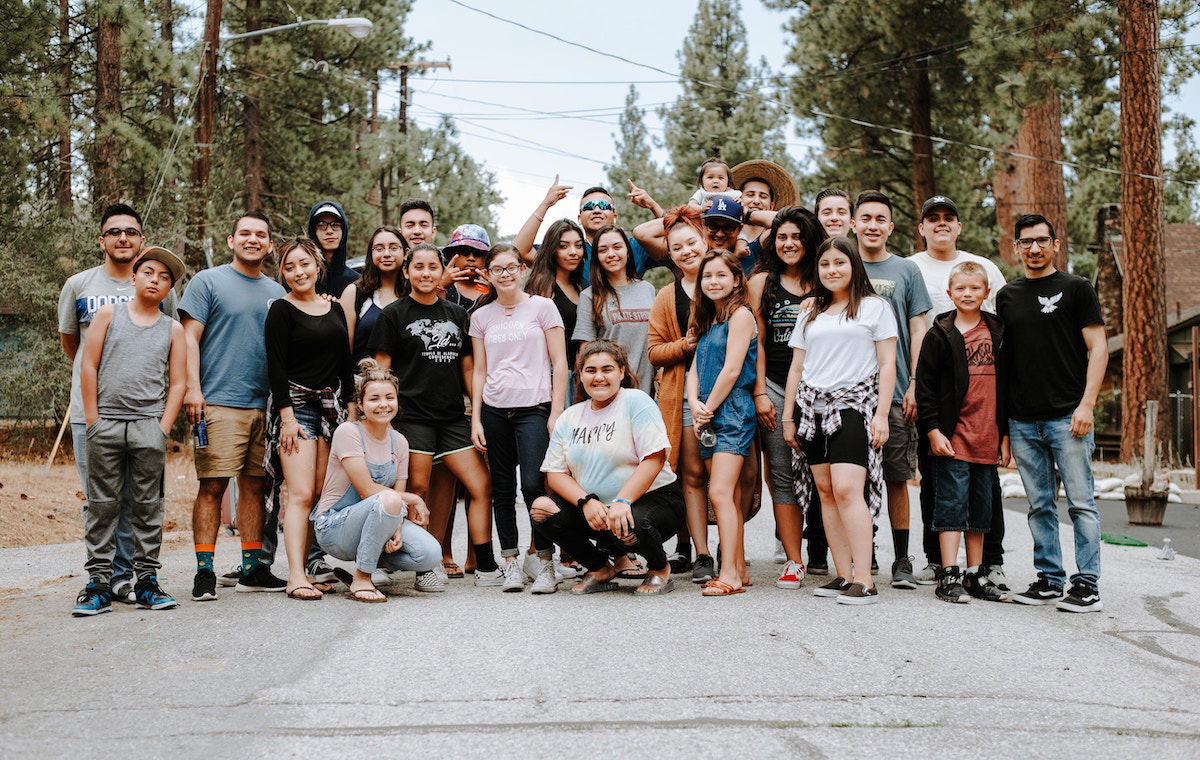 Large group of people posing on a road