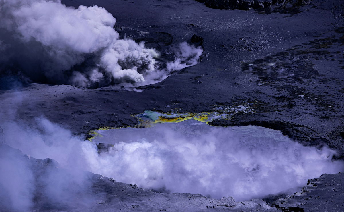 Landscape shot of a volcano wit steam coming out shot with a narrow aperture of f/10