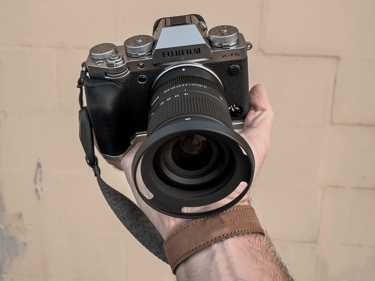 X-T5 Fujifilm camera and lens being held by someone's hand